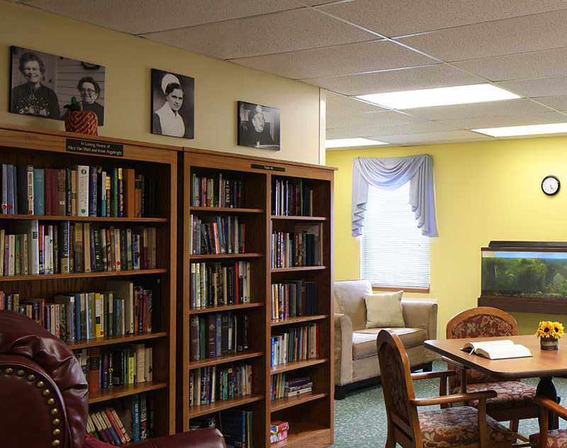 Multiple large bookshelves stocked with books in Madison, Virginia nursing home.